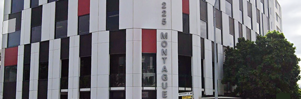 Google Maps street view of 225 Montague Road, West End. A tall white building on the corner of the street.